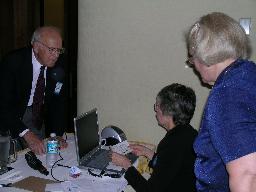 John Beukers checks up on convention functions with Ellen Lilley and Ellena Roland